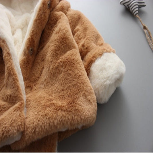 Brown and white fluffy blanket on a gray surface