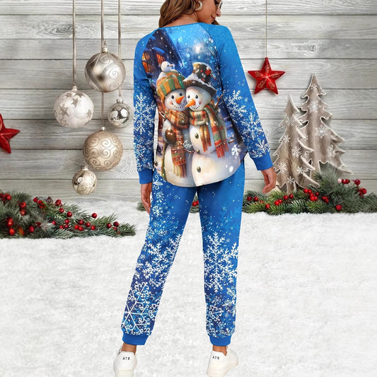 Person wearing a blue Christmas-themed outfit with snowmen and snowflakes in front of a decorated Christmas background.