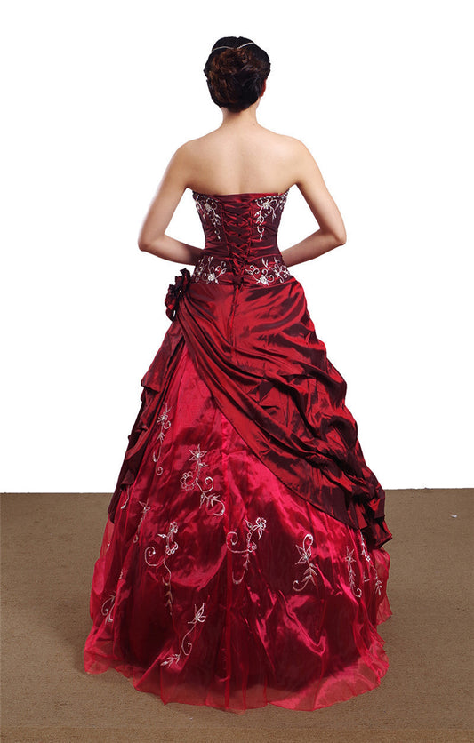 Red strapless gown with floral details on a white background