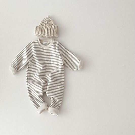 Striped baby romper with matching hat on a light gray background