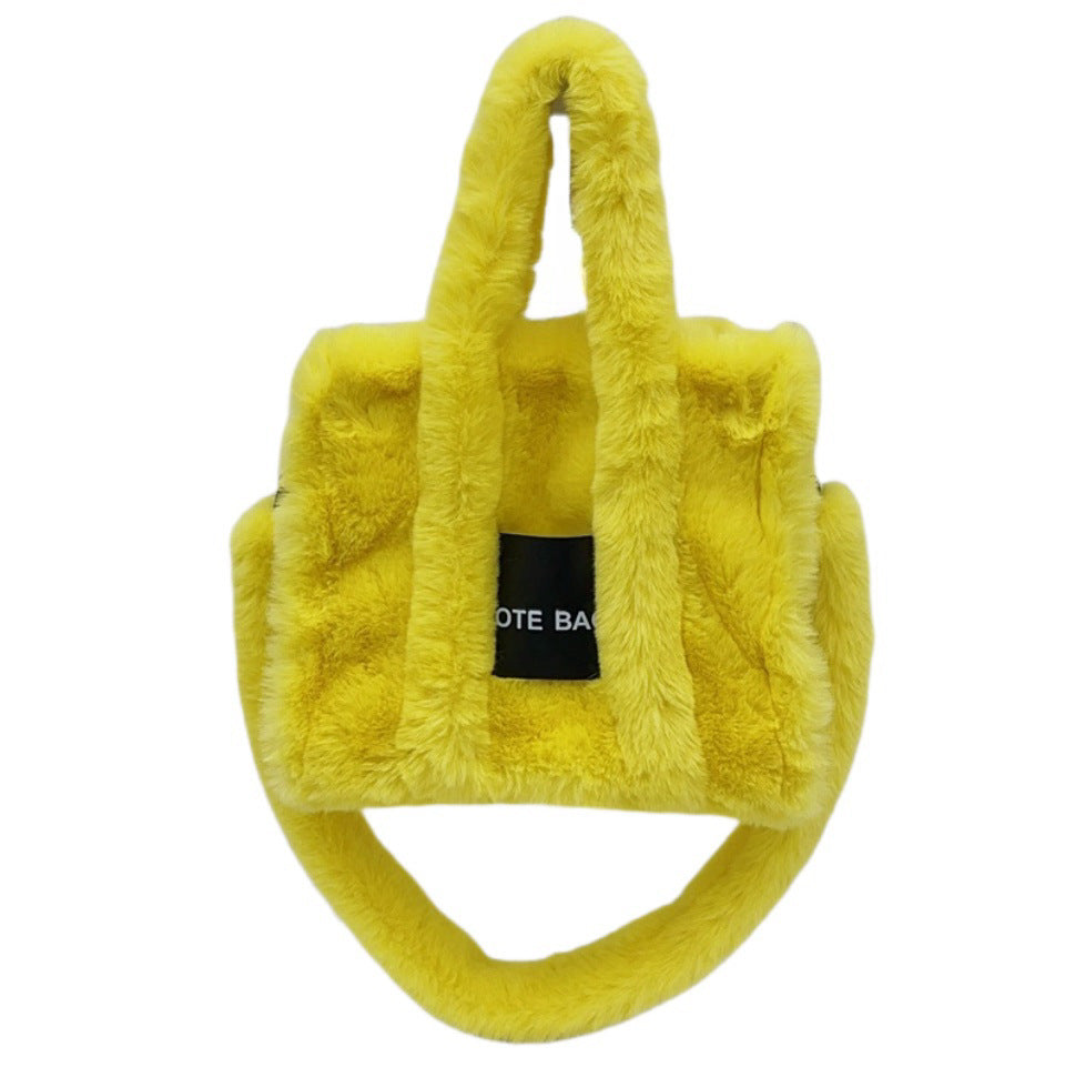 Yellow fluffy bag with a black tag on a white background