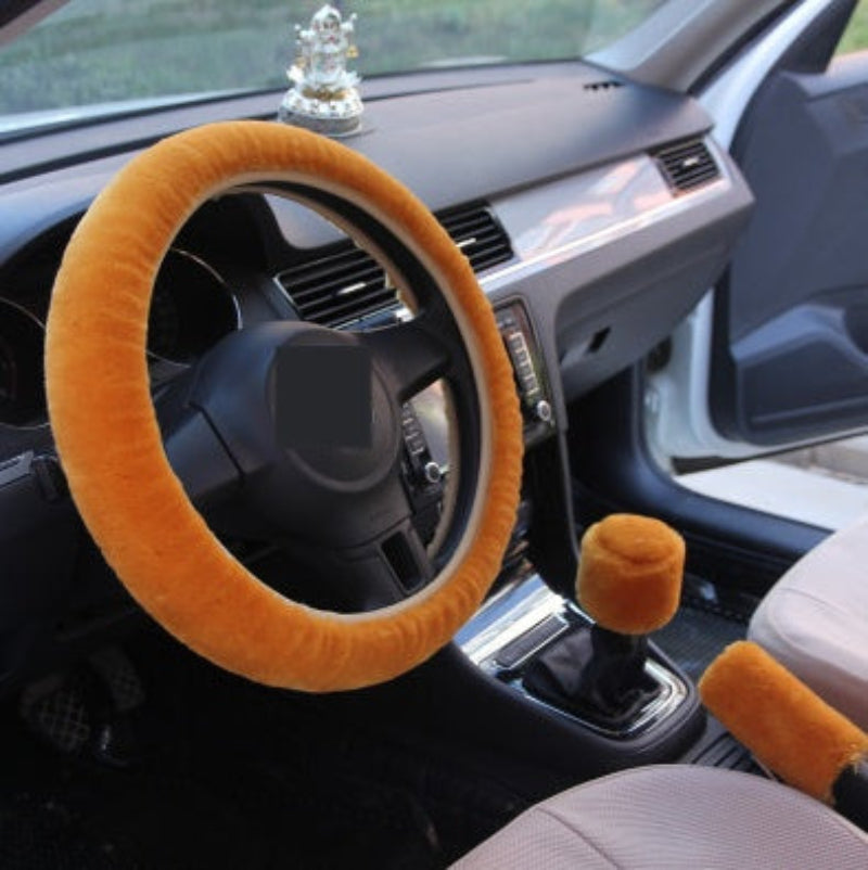 Car interior with orange steering wheel cover and gear shift cover