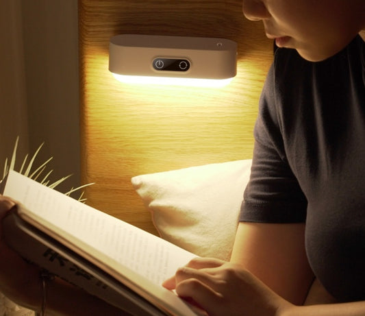 A LED night light with a magnetic base attached to a metal surface, providing a soft glow to the surrounding area.