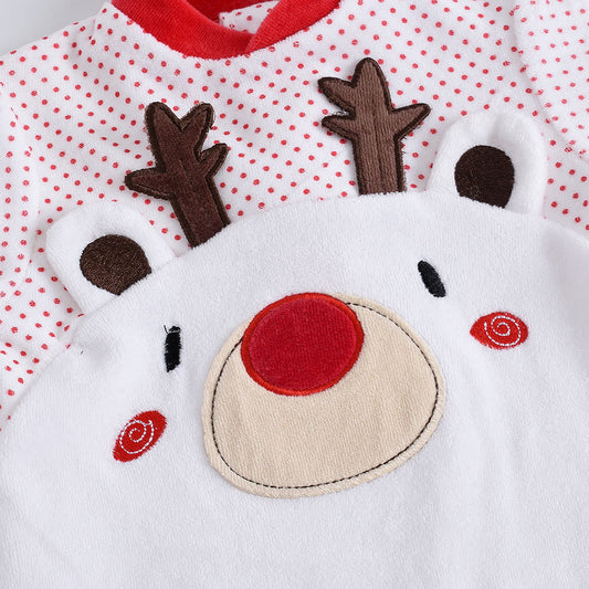 Close-up of a baby outfit with a reindeer face design on a white background with red polka dots.