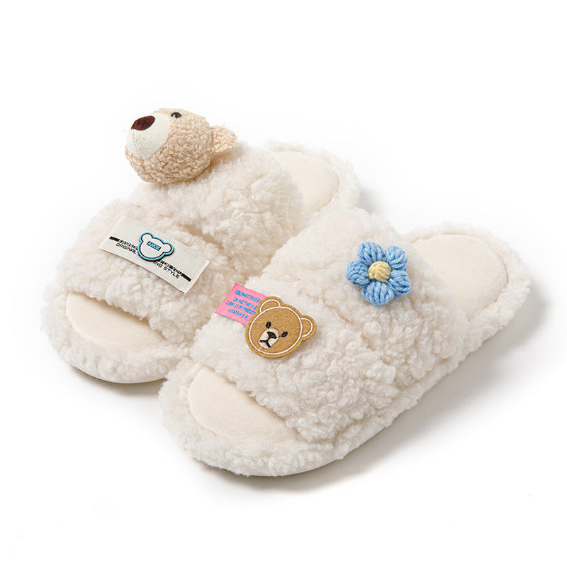 A pair of pink cartoon-style slippers with open toes and a character design, accompanied by a pair of white slippers with a similar design.