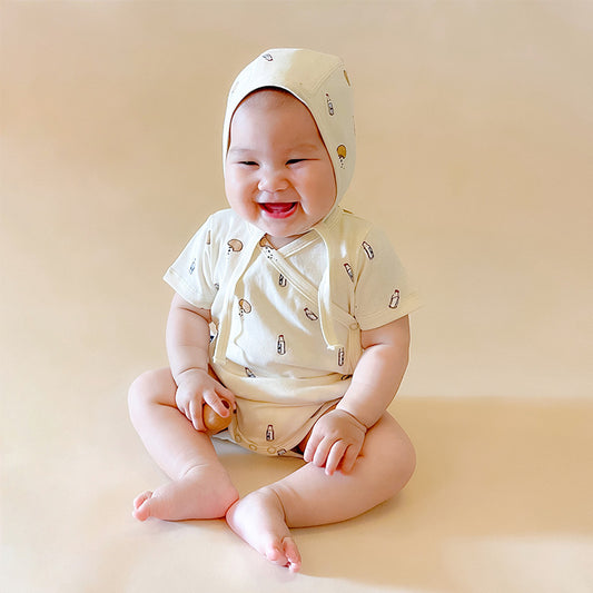Baby wearing a matching outfit with a beige background