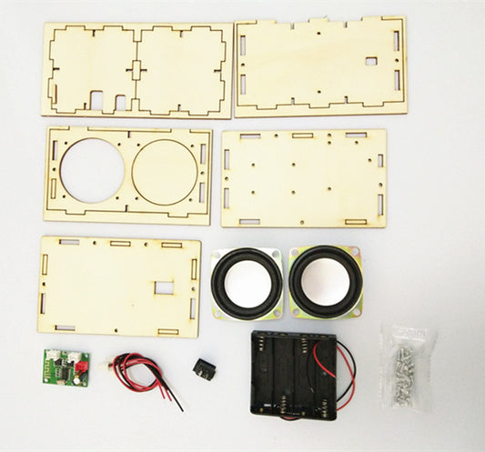 Components of a laser-cut wooden electronic project on a white background