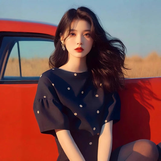 Woman in black outfit with red car in background