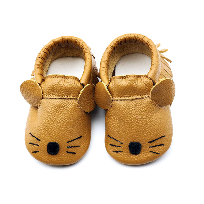 A pair of brown soft-soled toddler shoes with a cartoon animal design