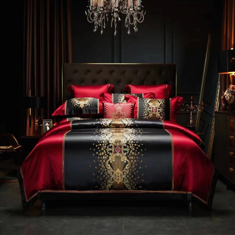 A four-piece silk cotton embroidery bed sheet set in black and red with gold embroidery, displayed on a bed with pillows and a duvet cover.