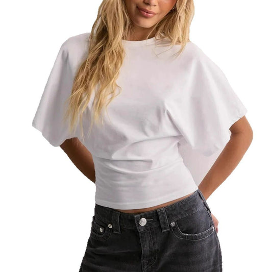 Person wearing a white crop top and black jeans on a white background
