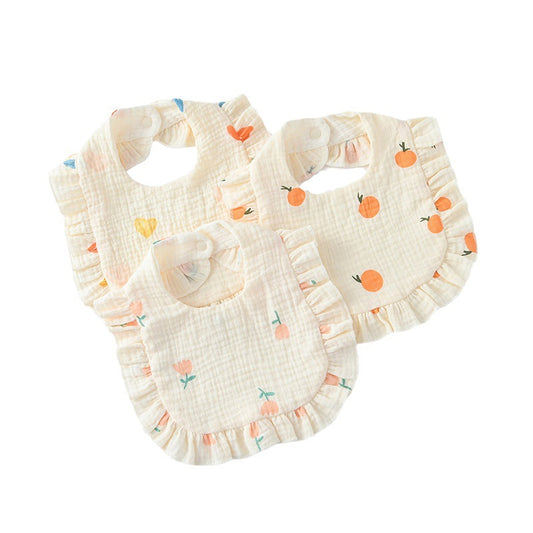 Set of two baby bibs with ruffled edges and fruit pattern on a white background