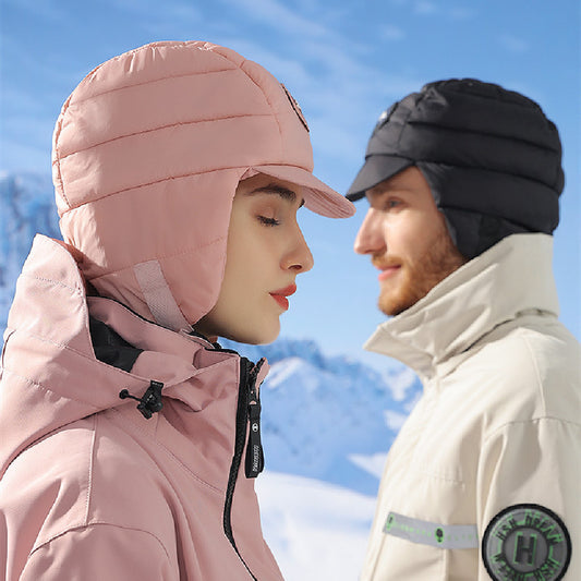 Two people wearing winter hats with a mountainous background