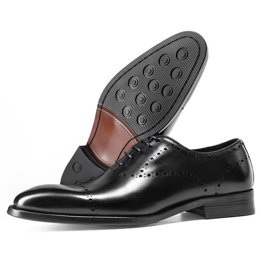 Black dress shoes with a focus on the sole and leather details on a white background
