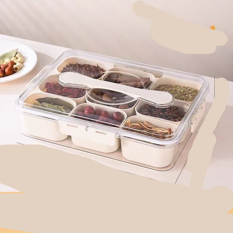 A person holding a transparent white spice storage box with multiple compartments, each filled with different spices.