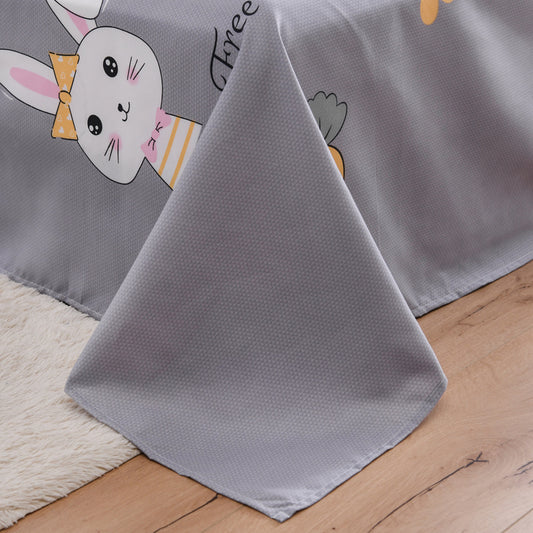Gray cartoon-themed blanket on a wooden floor