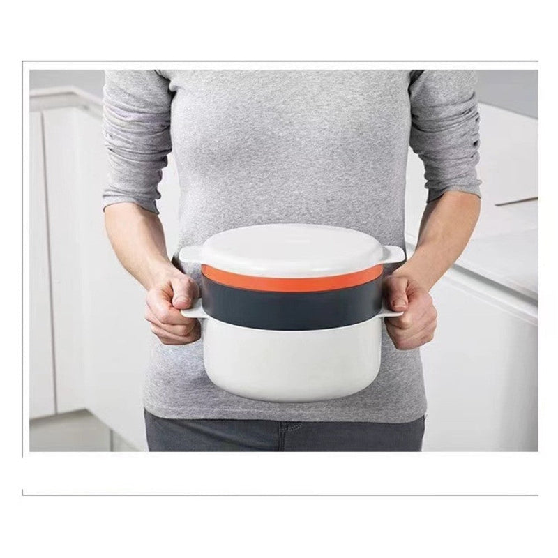 Person holding a white container with a red lid in a kitchen setting