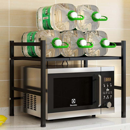 Microwave oven on a black metal rack with water bottles stacked above it.