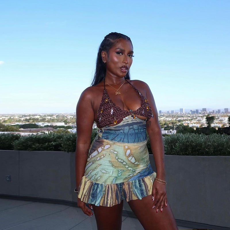 Woman in a colorful outfit standing on a rooftop with a cityscape in the background