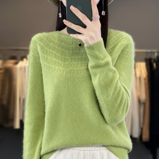 Person wearing a green sweater taking a mirror selfie in a clothing store.