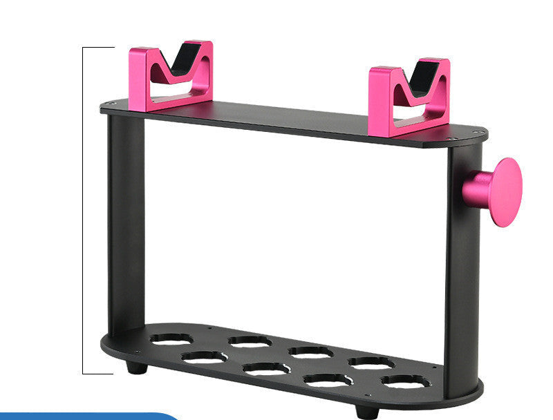 A black hairdressing styling rack with countertop holders featuring a hair dryer and various hair styling tools. The rack has gold and pink accents.