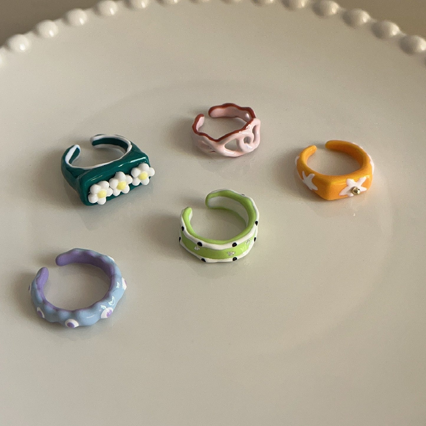 Set of colorful ceramic rings on a light gray surface