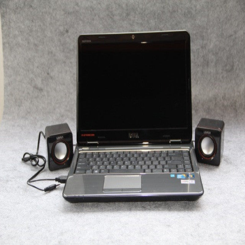 Laptop with speakers on a gray surface