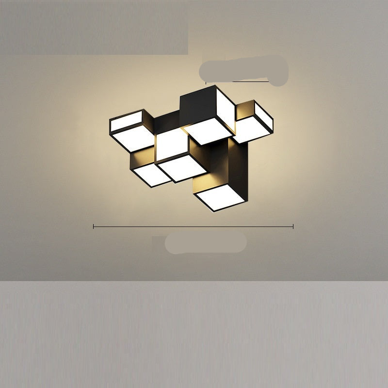 A modern black ceiling-mounted pendant light with multiple square-shaped灯heads hanging over a dining table in a contemporary room setting.