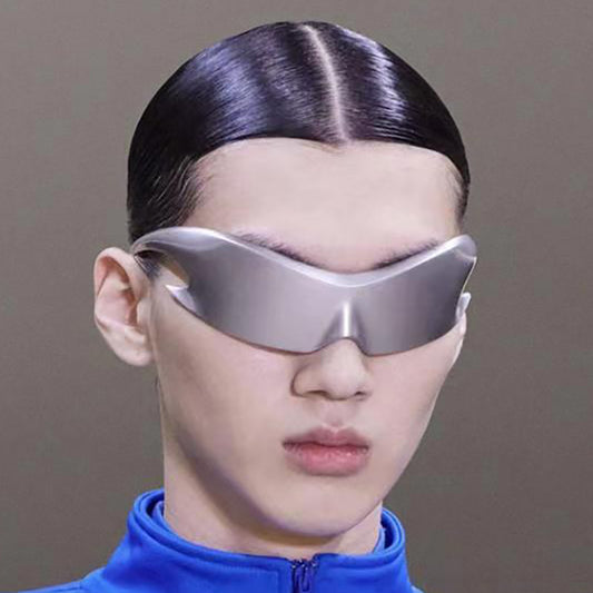 Person wearing futuristic silver eye masks with a plain background