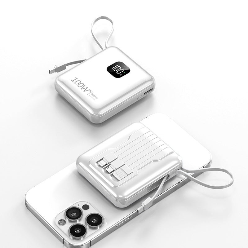 White power bank with digital display and cable, connected to a smartphone on a white background