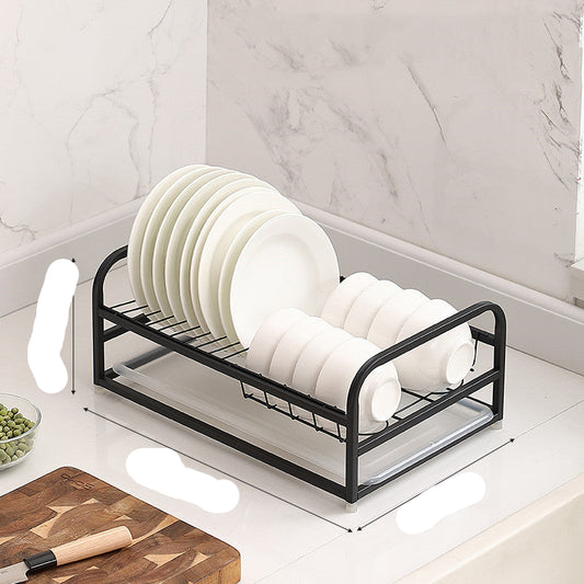 Black dish rack with white plates on a kitchen counter, showing dimensions.