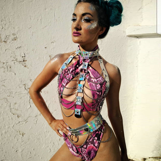 Woman in colorful outfit against a white wall