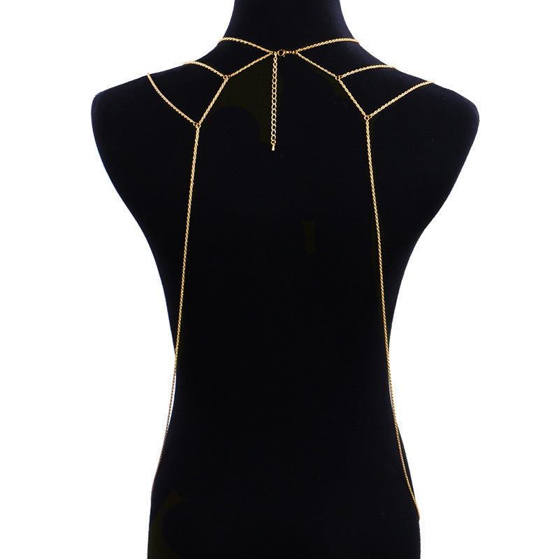 Gold chain body harness on a black mannequin