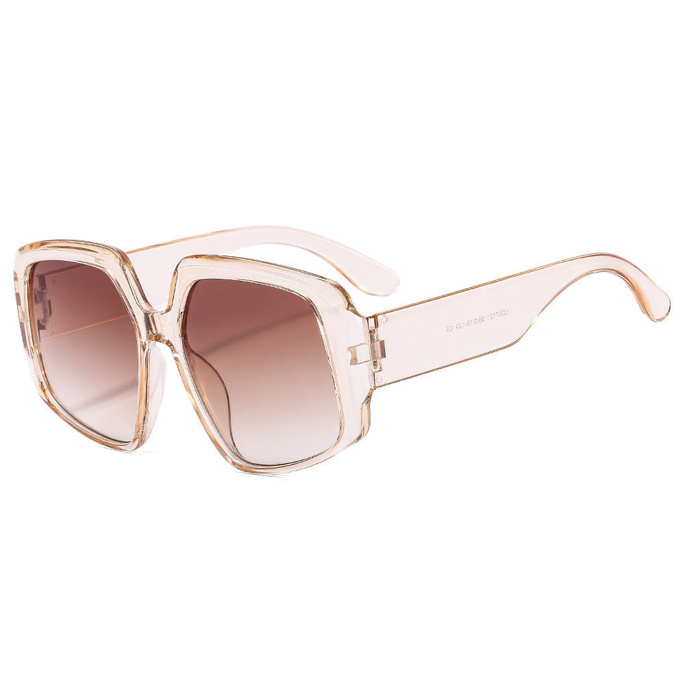 Sunglasses with a clear frame and brown gradient lenses on a white background