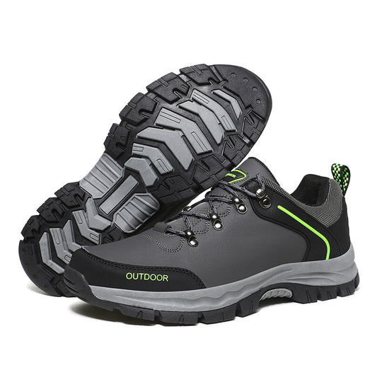 Gray hiking shoes with green accents on a white background