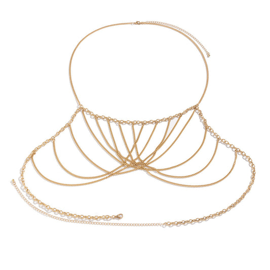 Gold chain necklace and body chain on a white background