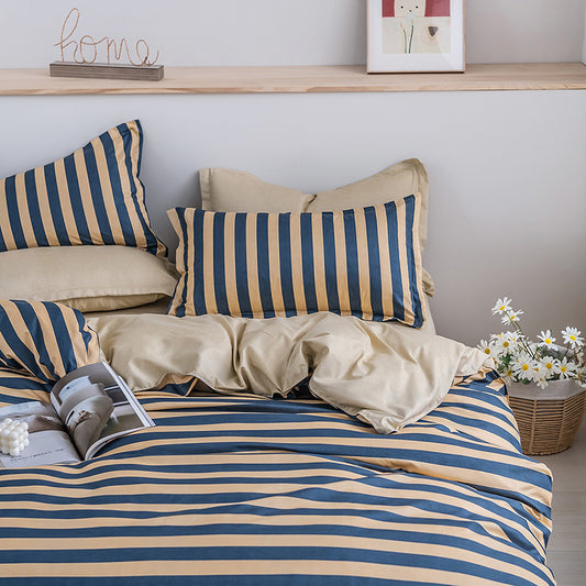 Striped bedding and pillows on a bed in a cozy room.