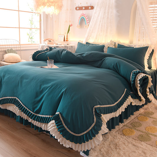 Teal bedspread with white trim in a cozy bedroom.