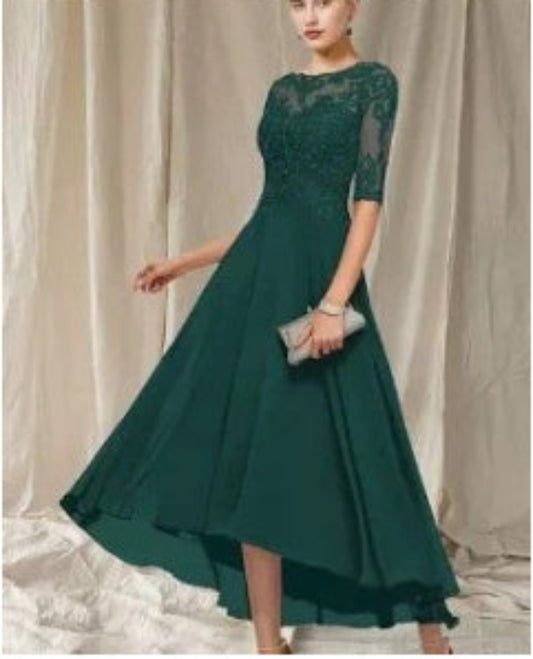 Green evening gown with lace detailing on a white background