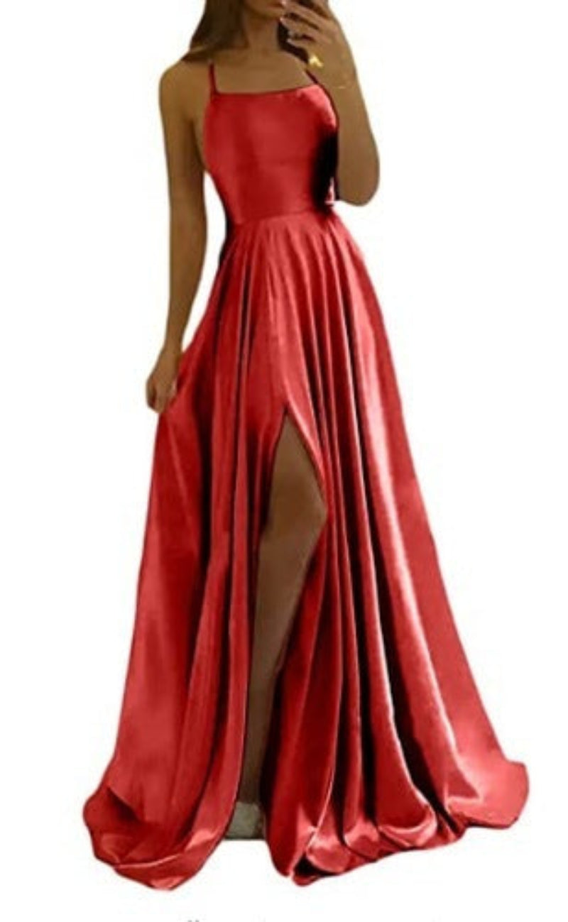 Red satin evening gown with a high slit on a white background