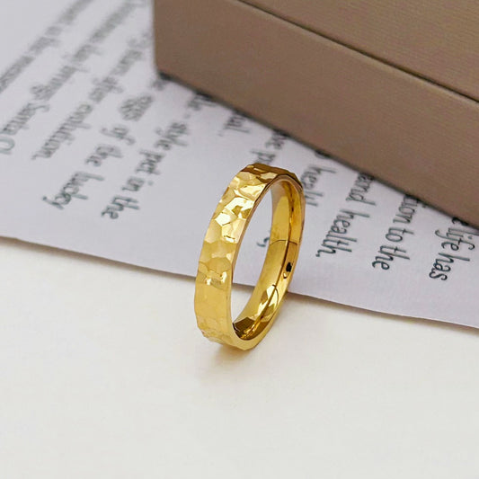 Gold ring on a piece of paper with text