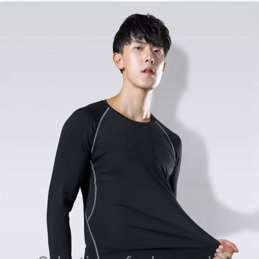 Person wearing a black long-sleeve athletic shirt on a light gray background