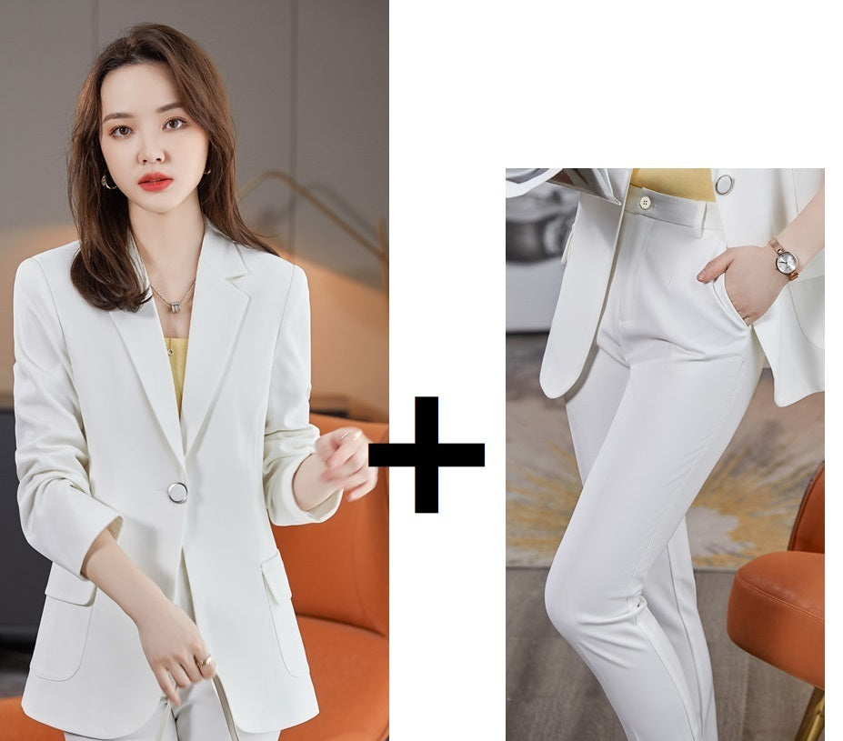 Woman wearing a white blazer coat and pants with close-up details.