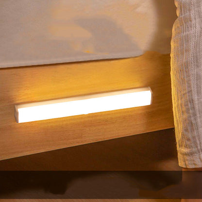 Modern wall-mounted light fixture on a wooden surface