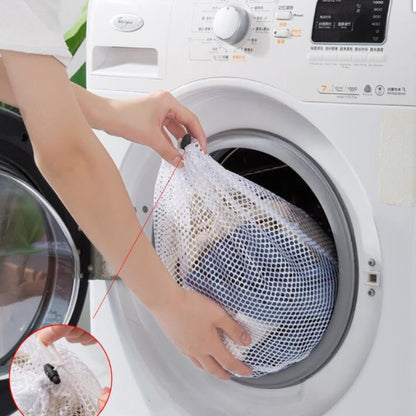 Person placing a mesh laundry bag into a washing machine with an inset showing a close-up of the bag.