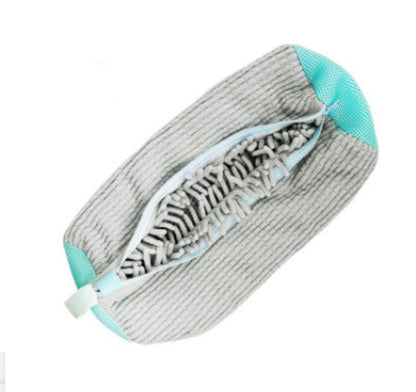 A gray and blue striped shoe bag with a zipper closure and a small white and blue label attached to it.