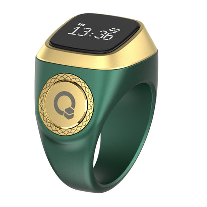 Green and gold smart ring with digital display on a white background