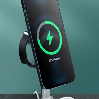 Smartphone with charging display on a stand against a teal background