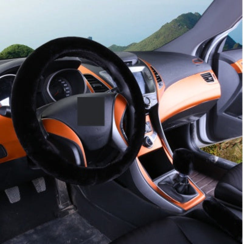 Car interior with orange and black dashboard and steering wheel.