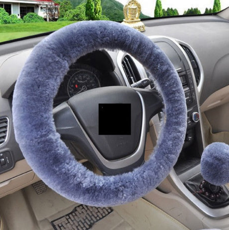Blue steering wheel cover on a car steering wheel with a blurred background